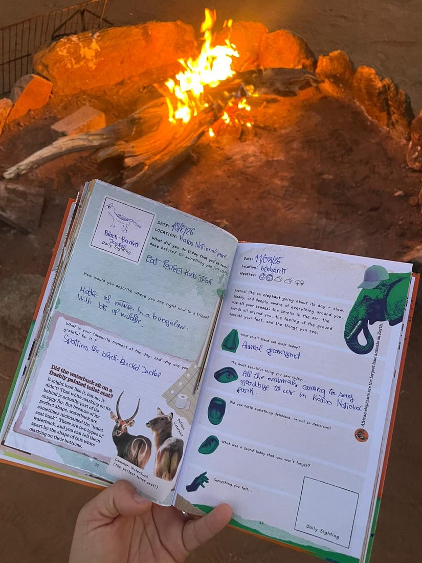 The African Safari Journal open beside a campfire