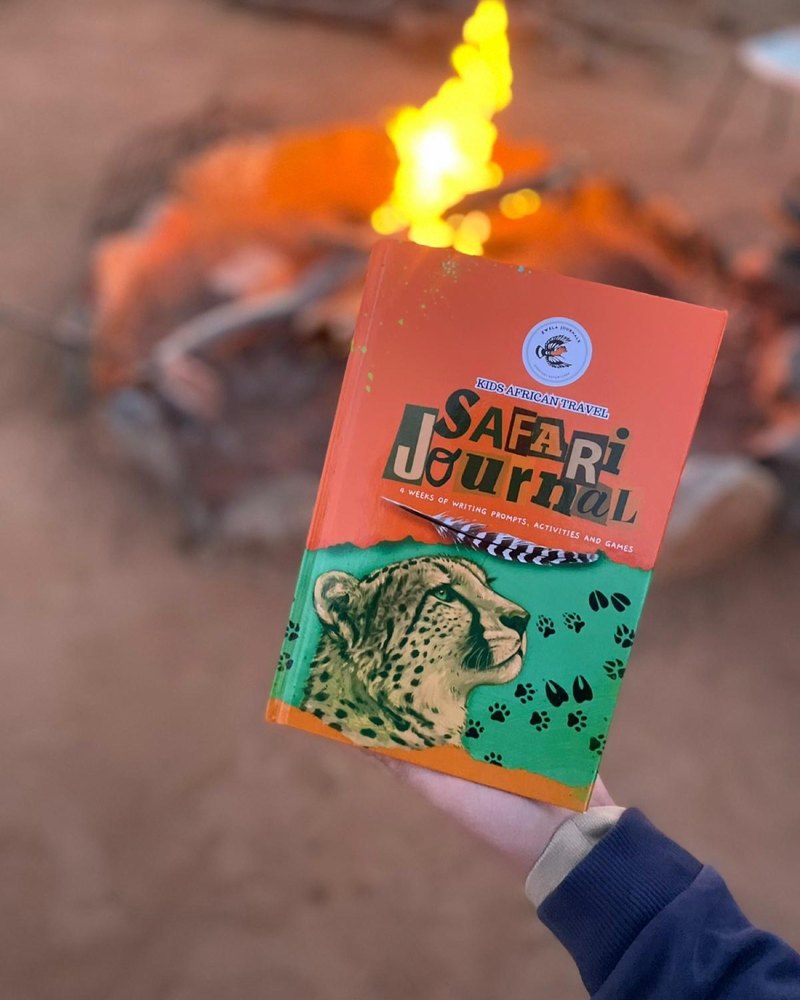 The African Safari Journal beside a campfire